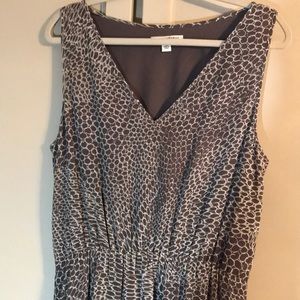 Long, sleeveless mocha and cream colored dress.